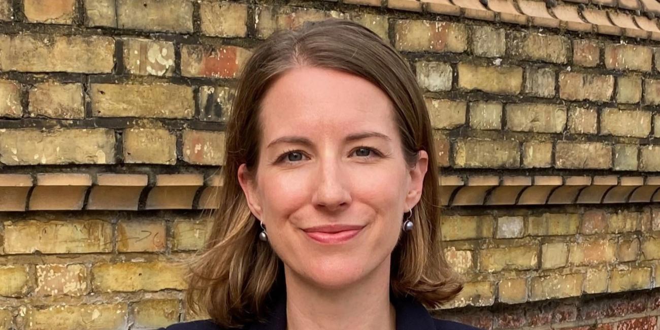 Woman in front of old brick wall