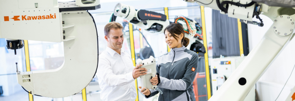 A researcher showcasing their findings surrounded by machinery.
