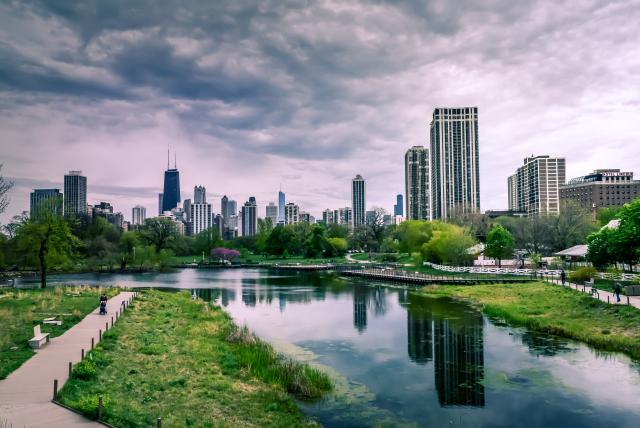 Green city with river and landscape of buildings in the background