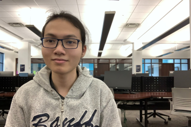 Andrew, smiling while working in the computer labs