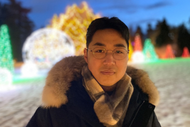 Ian smiling, in front of Van Dusan Botanical Garden on Christmas Eve