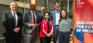Government ministers pose with faculty and staff from the UBC School of Biomedical Engineering