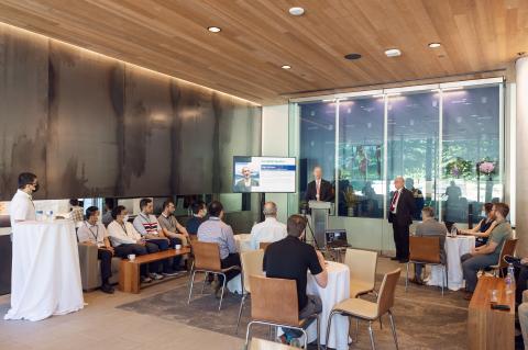 People gathered around listening to a speaker