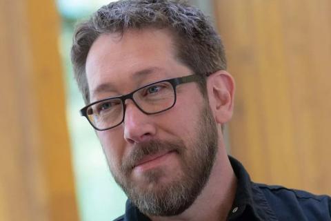 Professor Blair Satterfield looking away from the camera, smiling.