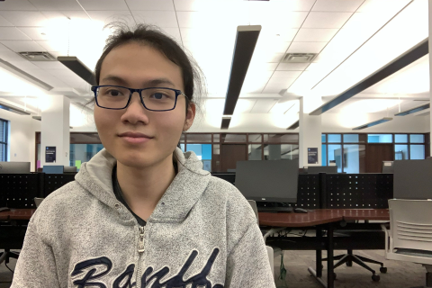 Andrew, smiling while working in the computer labs